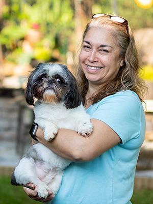 Portrait of Maria RIcketts with her dog.